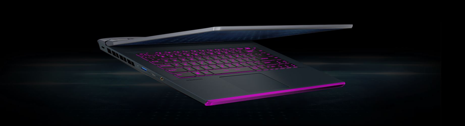 A slightly opened GE66 Raider laptop is emitting purple light.